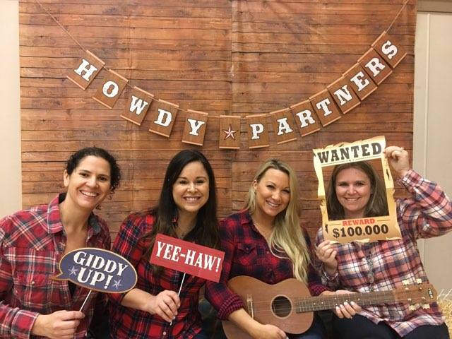 4 adults taking a cowboy photo